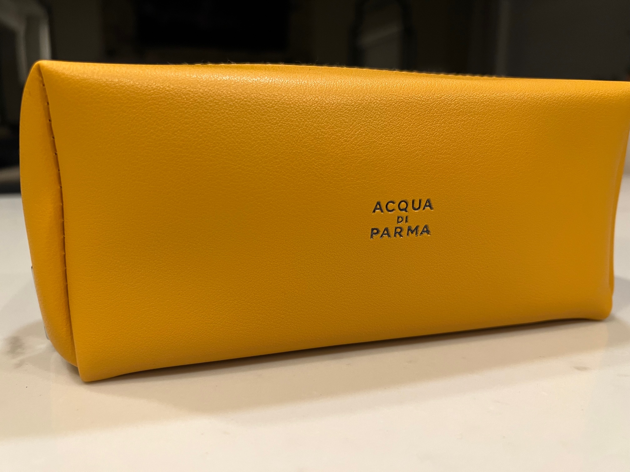 a yellow case on a white surface